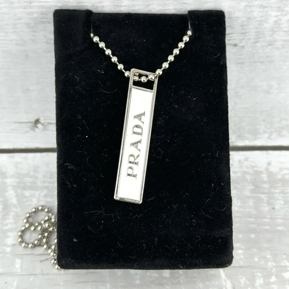 Prada charm w/bonus gift. AUTHENTIC White and silver.
